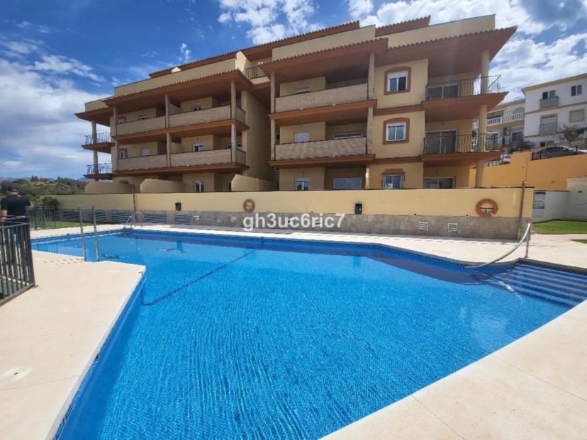 Modern 2-bedroom apartments in El Faro with communal pool.